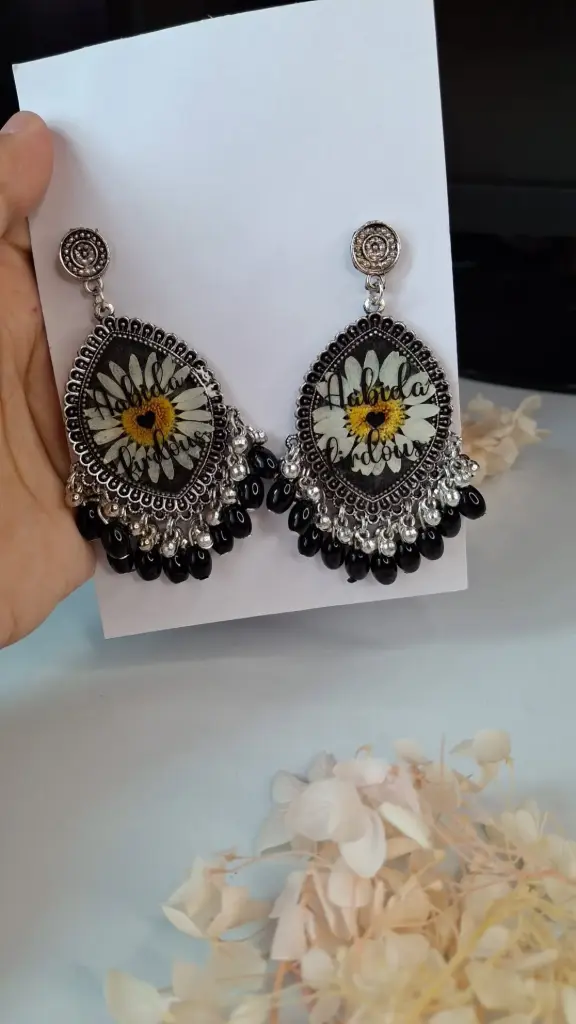 Black framed with white flower resin earring.