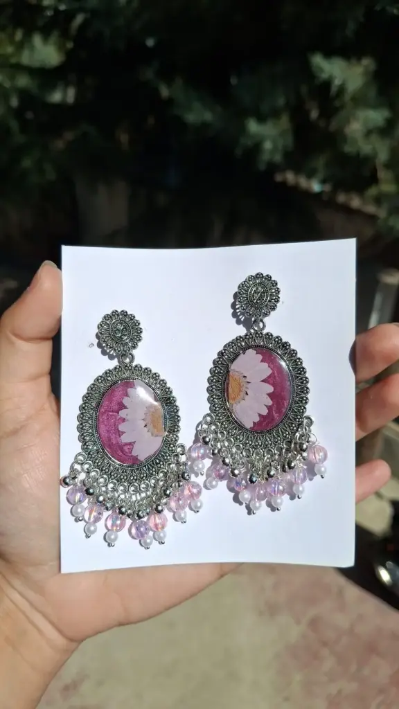silver framed pink glitter resin earring.