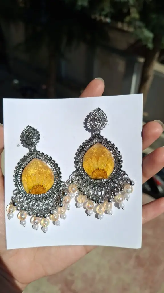 Silver framed gold resin earring.
