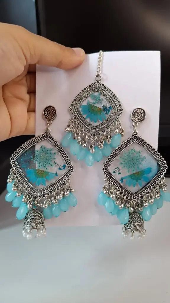 Beautiful blue flowered resin earring and pendant combo.